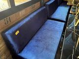 a blue couch and some chairs in a room