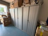 many boxes and boxes stacked on top of each other in a storage room