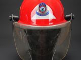 a red fireman ' s helmet with a clear visor