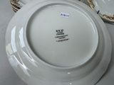 a white plate with a gold rim and a white plate with a gold rim and a white plate with a gold rim and a white plate with a gold