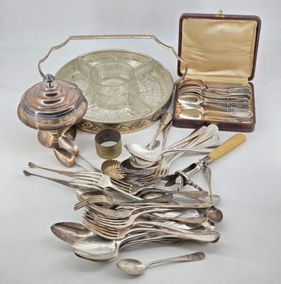 a lot of silver spoons and silverware on the table