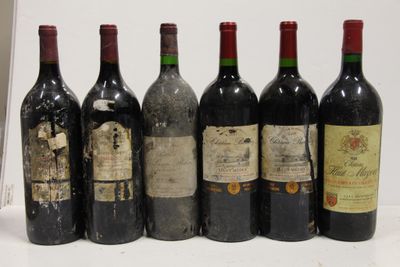 six bottles of wine are lined up in a row on a table