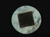 a small metal object with a black square in the middle