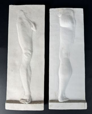 a pair of plaster sculptures of a man and a woman