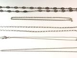 a lot of different chains on a white surface