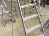 many ladders that are sitting in a room