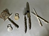 a knife, fork, spoon, and other items that are on the table