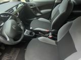 the interior of a car with the door open and the driver ' s seat down