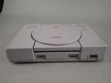 a white sony game console sitting on a table