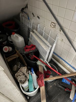 an image of a bathroom with a lot of clutter on the floor
