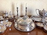 a table with a lot of silver items on it