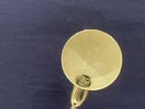 an image of a brass plated lamp on a blue background