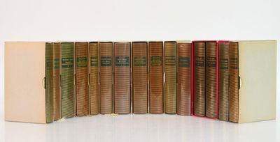 plusieurs vieux livres sont alignés sur une surface blanche
