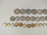 a close up of a row of coins on a white surface
