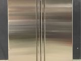two stainless steel refrigerators sitting side by side
