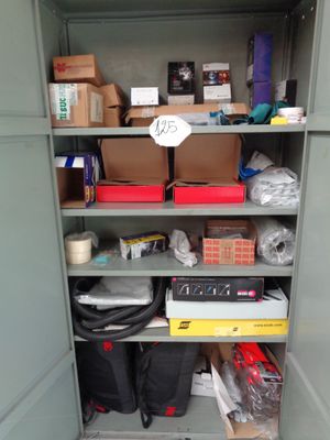 a cupboard with many items in it in a room