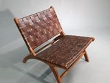 brown woven leather chair with wooden frame and foot rest
