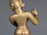 an image of a gold statue of a woman on a marble base