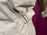a close up of a woman ' s dress with a belt on a mannequin mannequin mannequin mannequin mannequin mannequin