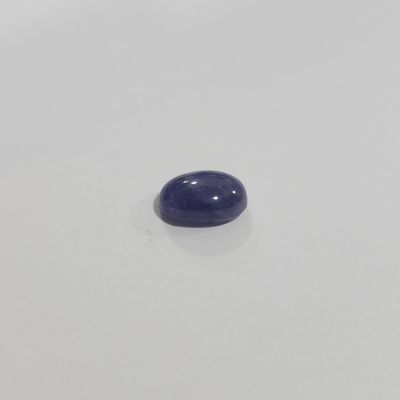 a close up of a blue stone on a white surface