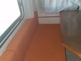 a couch and a table in the corner of a camper