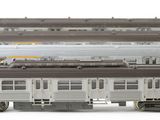 two trains that are sitting side by side on a white surface