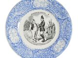a blue and white plate with a picture of a man and a woman on it