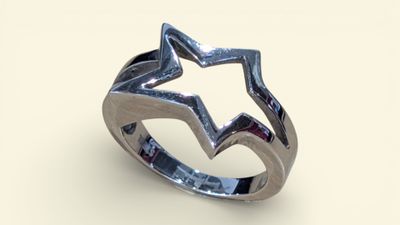 a close up of a silver ring with a star on it