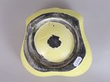 a yellow bowl with a black and white design on it