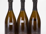 three bottles of champagne sitting next to each other on a table