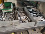 many different tools in a metal box on a table