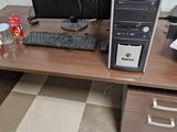 a desktop computer sitting on a desk with a keyboard and a monitor