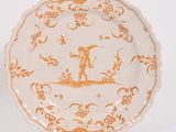 une assiette ornée d'un motif orange et blanc