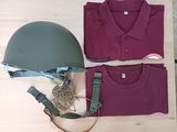 a helmet, t - shirt and other items laid out on a table