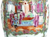 a large vase with a painting on it sitting on a table