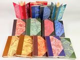 many different colored books stacked on top of each other