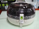 an image of a white and black air fryer on a table