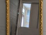 a mirror that is sitting on the floor next to a wall
