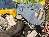 a pile of clothing and flowers on a table