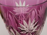 a purple glass bowl sitting on a table