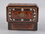 a small wooden box with a decorative design on it