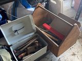 a box of tools sitting on the floor next to a suitcase