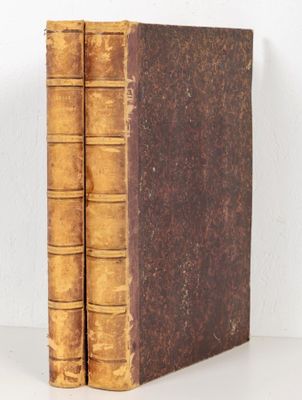 an old book sitting on top of a table next to a white wall