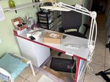 a desk with a chair and a lamp on it