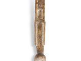 a close up of a wooden object on a white surface