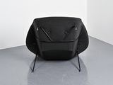 a black chair that is sitting in the corner of a room