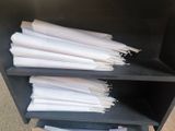 a lot of papers that are stacked on a shelf
