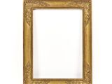 an antique gold frame with a decorative pattern on a white background