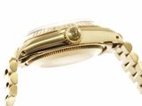 a close up of a gold watch with a chain around it