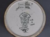 a close up of a plate with a coat of arms on it